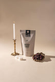 Necromancer Pucker Punch Coffee bag next to blackberries and candles.