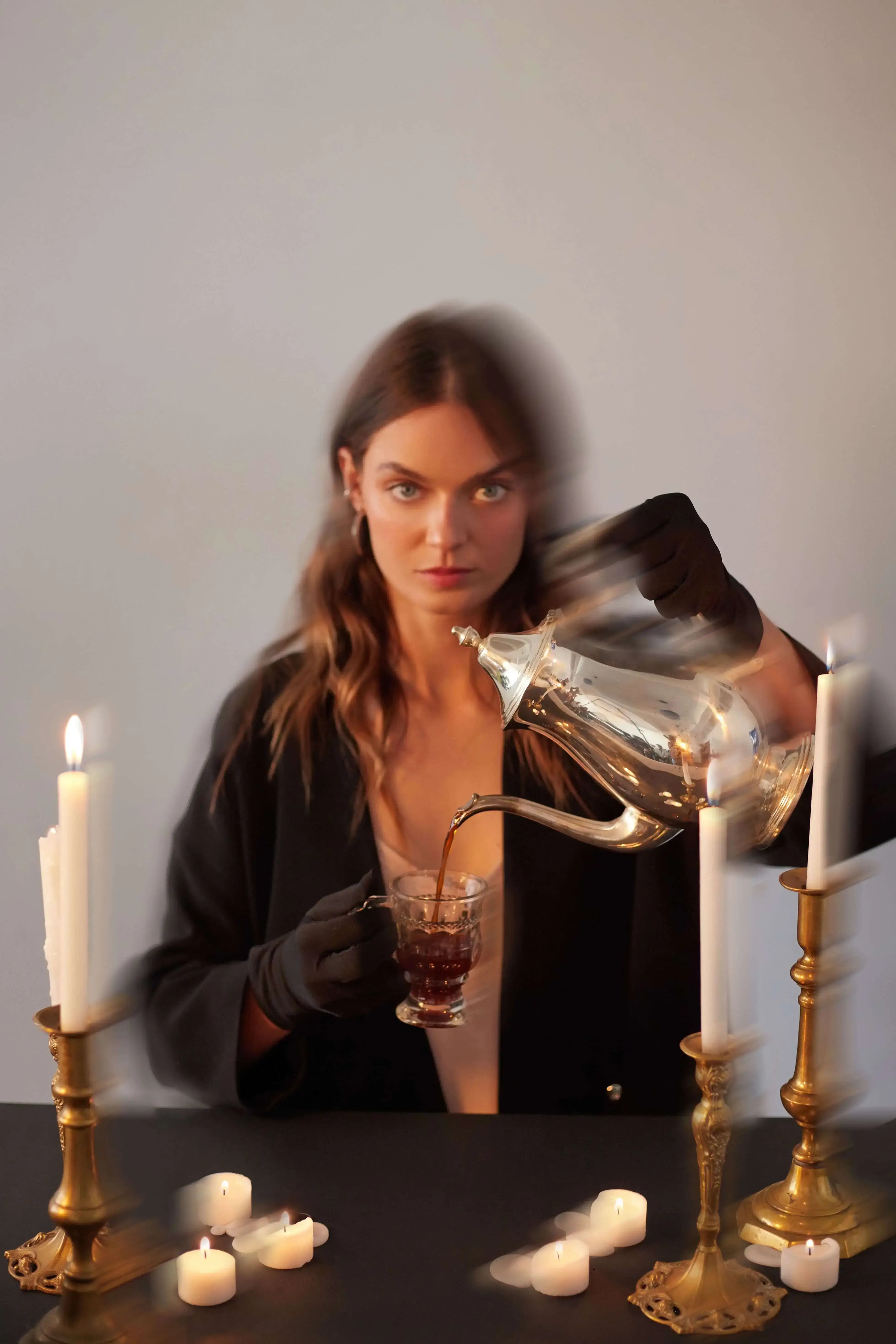 woman pouring a cup of coffee.